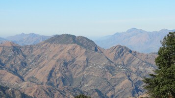 A mountainous landscape with rugged terrain and scattered buildings.