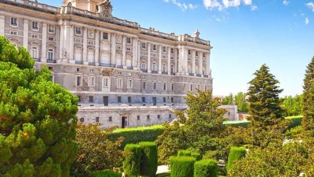 A large, historic building with classical architecture, surrounded by well-maintained gardens and trees. - Hostal Abaaly (Madrid)