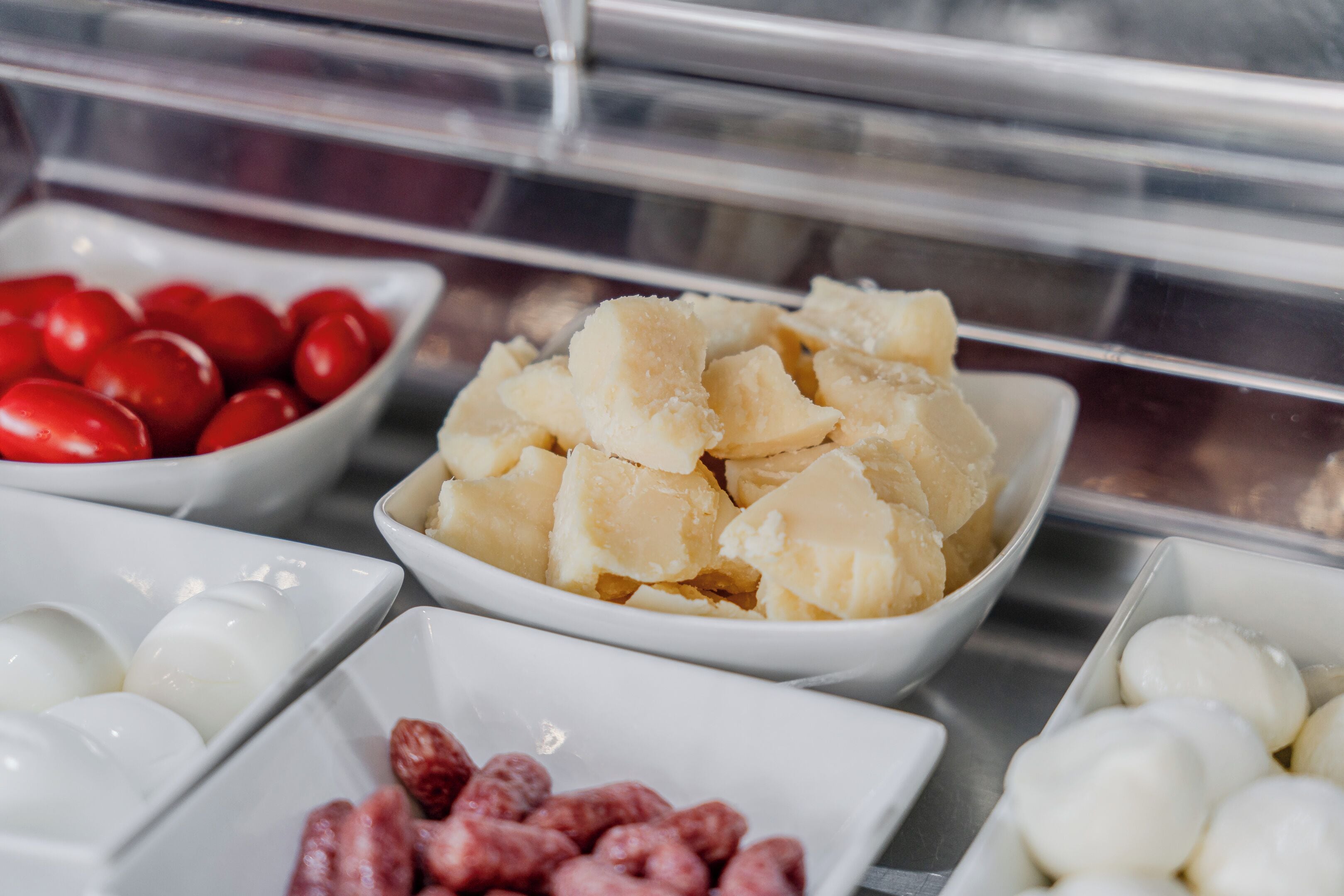 A display of various food items in a buffet setting.