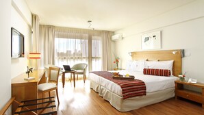 A hotel room with a bed, desk, chair, and a window with curtains. - BA Sohotel (Buenos Aires)