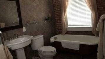 A bathroom with a sink, toilet, and bathtub.