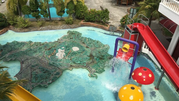 A water park with slides and water features, surrounded by greenery. - Landcons Hotel (Langkawi)