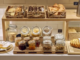 A display of baked goods and preserves in a bakery setting.
