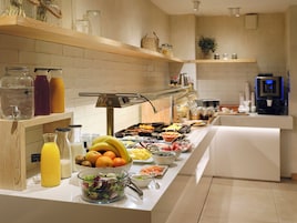 A buffet with various food items and beverages.