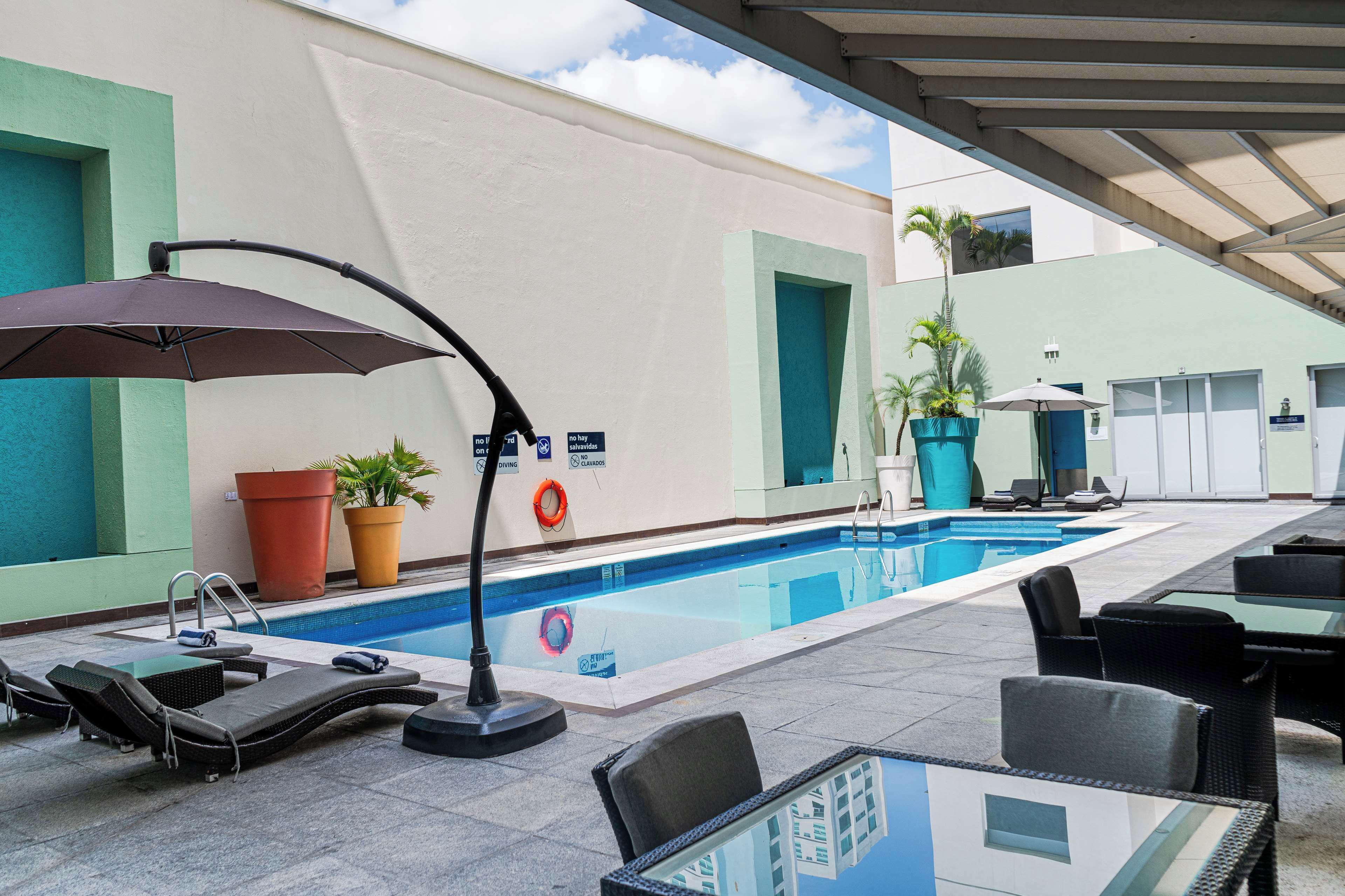 outdoor pool, open 9:00 am to 9:00 pm, pool umbrellas