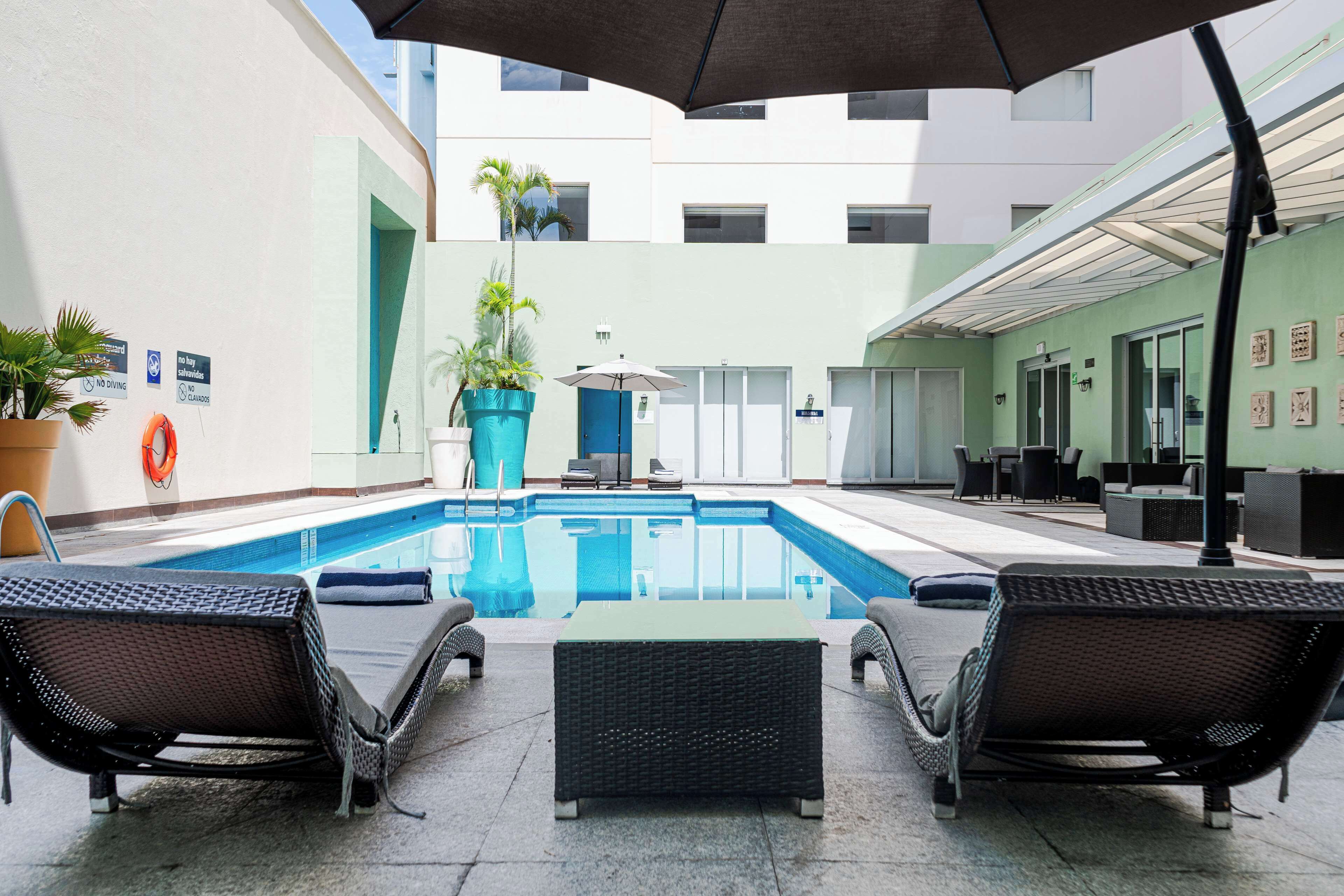 outdoor pool, open 9:00 am to 9:00 pm, pool umbrellas