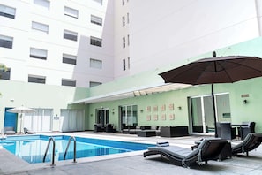 Outdoor pool, open 9:00 AM to 9:00 PM, pool umbrellas