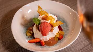 A dessert on a ceramic plate with a wooden table background.