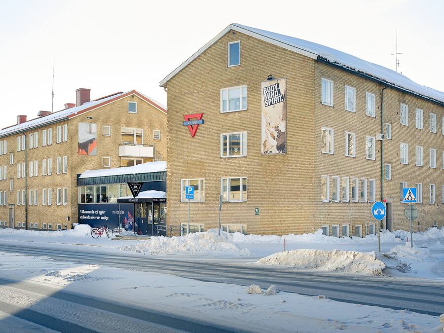 A multi-story brick building with a large sign on the front.