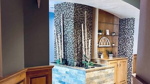 A modern kitchen with a built-in island, wooden cabinetry, and a tiled backsplash. - Peek'n Peak Resort Trademark Collection by Wyndham (Clymer)