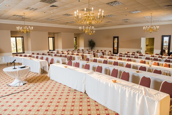 A banquet hall with rows of tables, chairs, and chandeliers. - Peek'n Peak Resort Trademark Collection by Wyndham (Clymer)