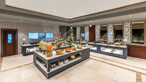 A spacious lobby with a marble floor, a reception desk, and a large window with patterned curtains. - Sterling Amargarh Jodhpur (Luni)