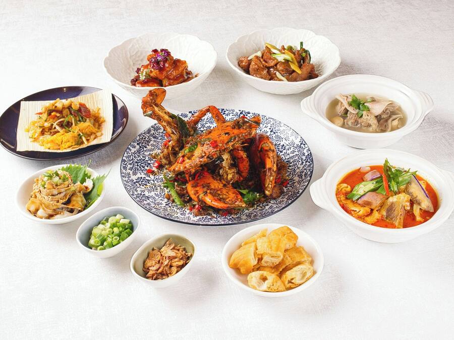 A variety of dishes including a whole roasted chicken, several bowls of soup, and a plate of fried items.