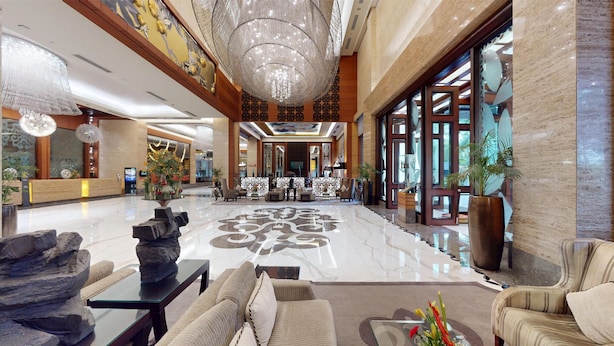 A spacious lobby with a marble floor, a reception desk, seating area, and a large chandelier. - Radisson Blu Hotel Nagpur (Nagpur)