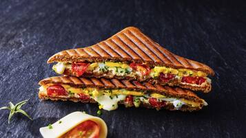Un sándwich a la parrilla con capas visibles de ingredientes.