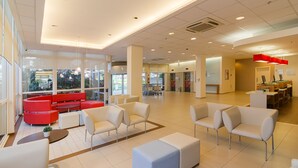 A spacious lobby with modern seating, large windows, and a reception area. - Ibis Canoas Shopping (Canoas)