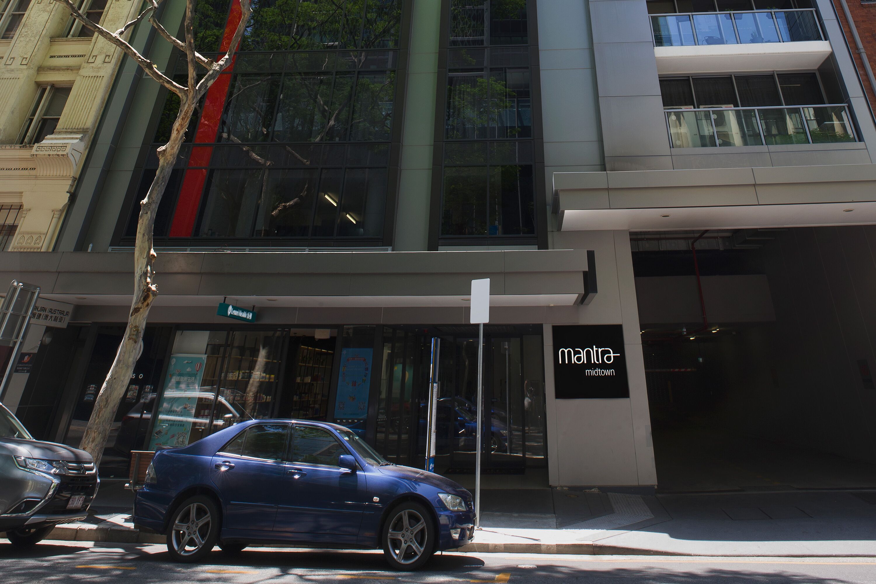 A modern building with a sign for 'mantra midtown'.