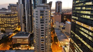 A high-rise building with multiple floors, surrounded by other tall buildings. - Mantra Midtown (Brisbane)