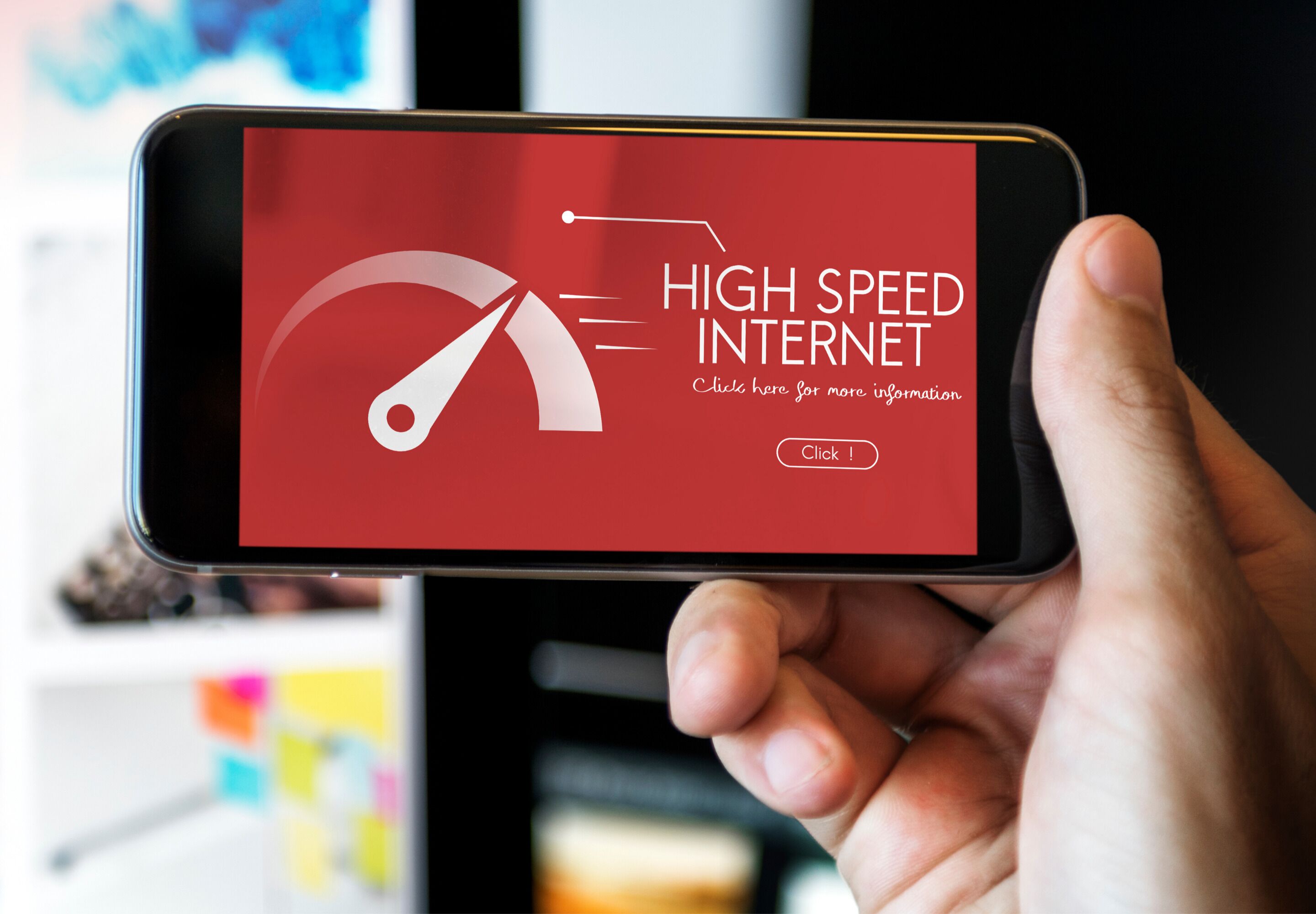 Une main tenant un smartphone affichant une publicité pour un service Internet haut débit.