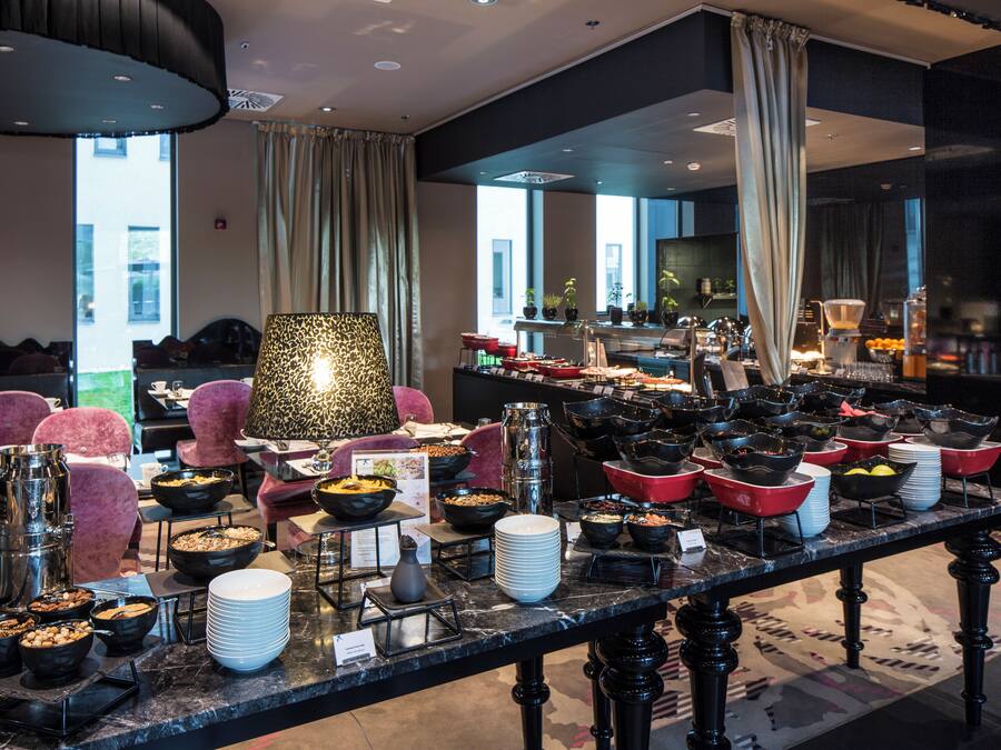 A buffet setup with various food stations and seating areas.