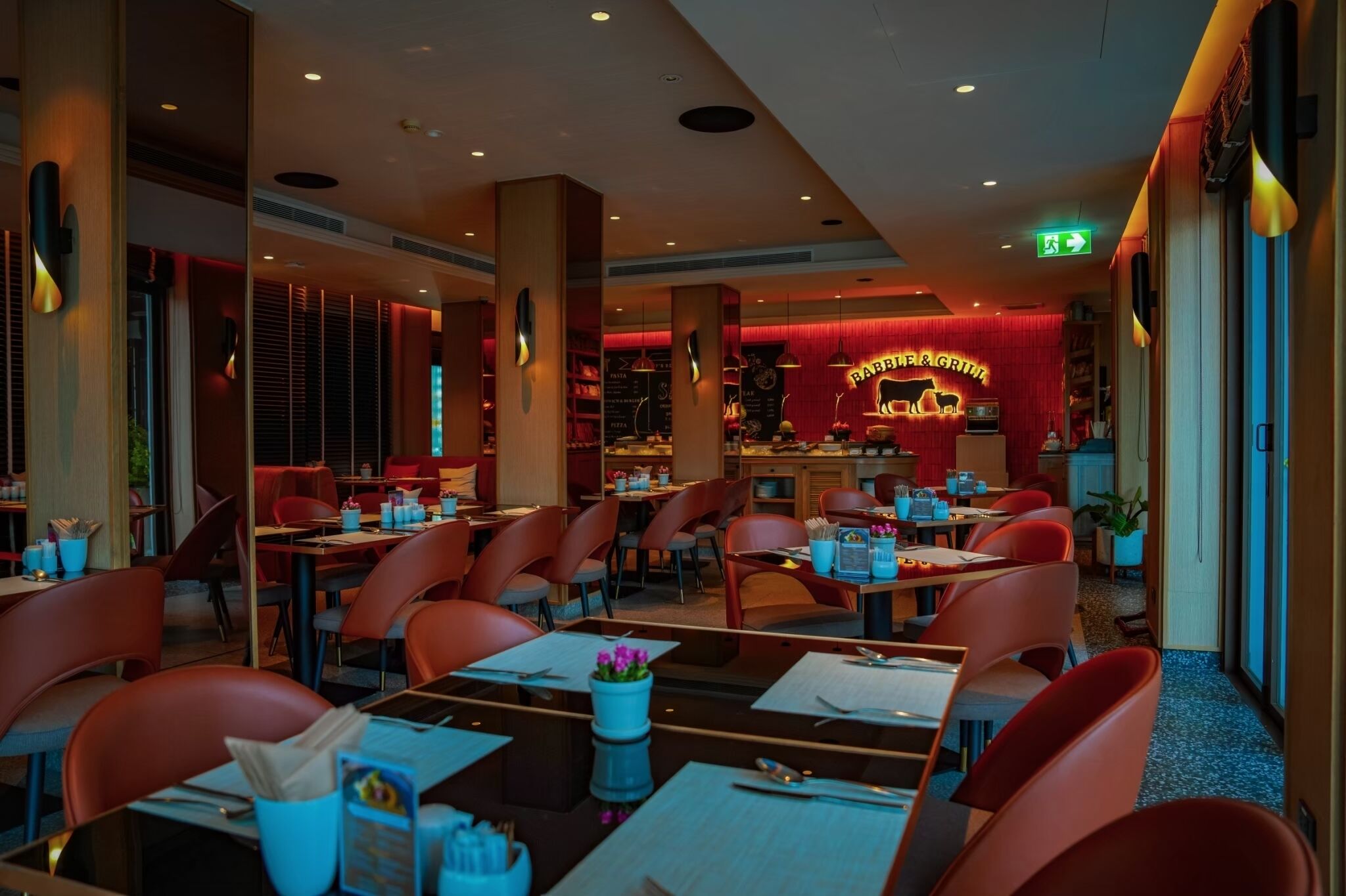 A restaurant with red chairs, tables, and a neon sign reading "BARBERRY".