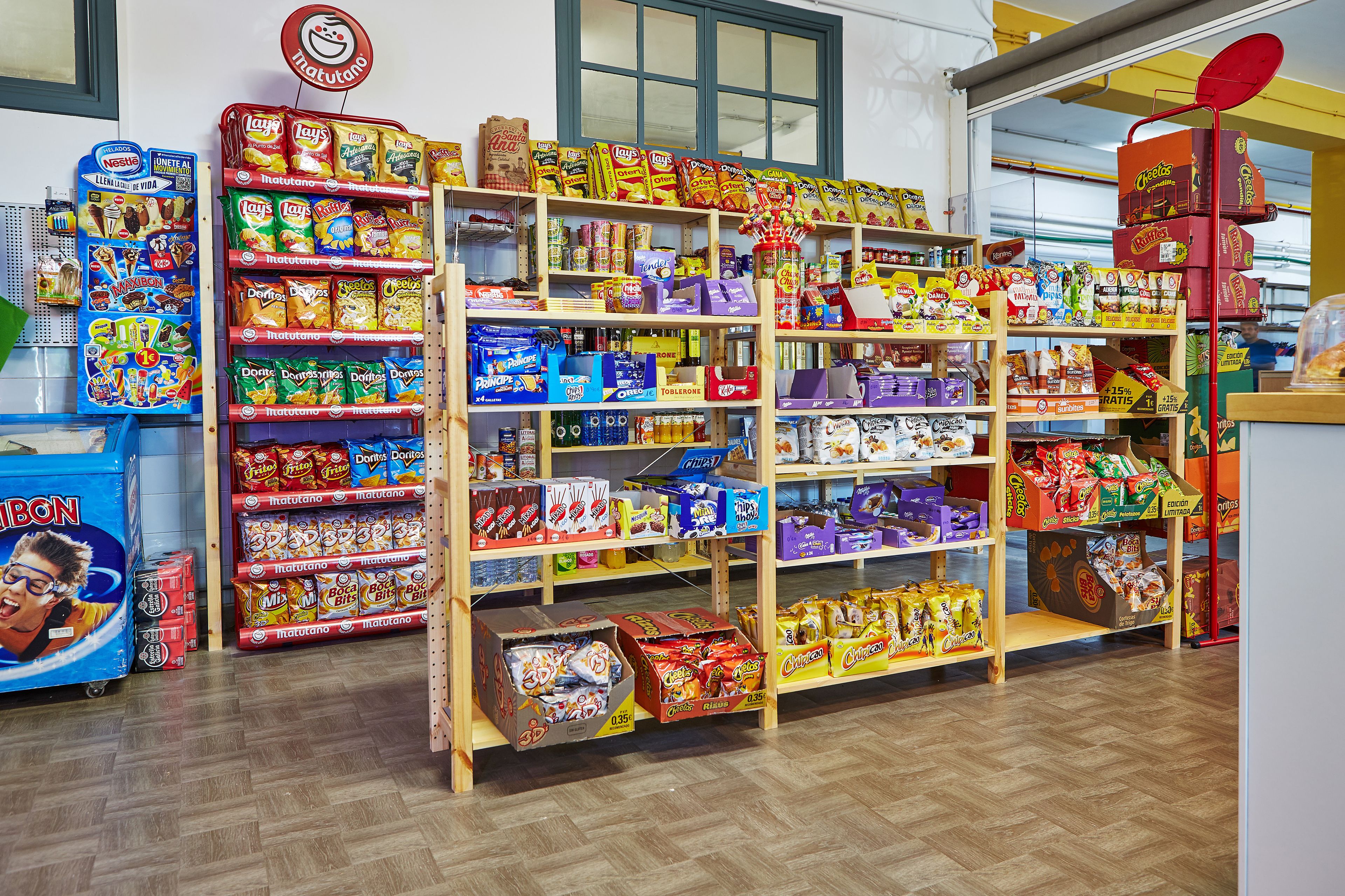 A snack aisle in a store with various brands and products.