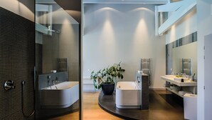 A modern bathroom with a glass shower enclosure, a freestanding bathtub, and a vanity with a mirror. - Lafitenia Resort (Saint-Jean-de-Luz)