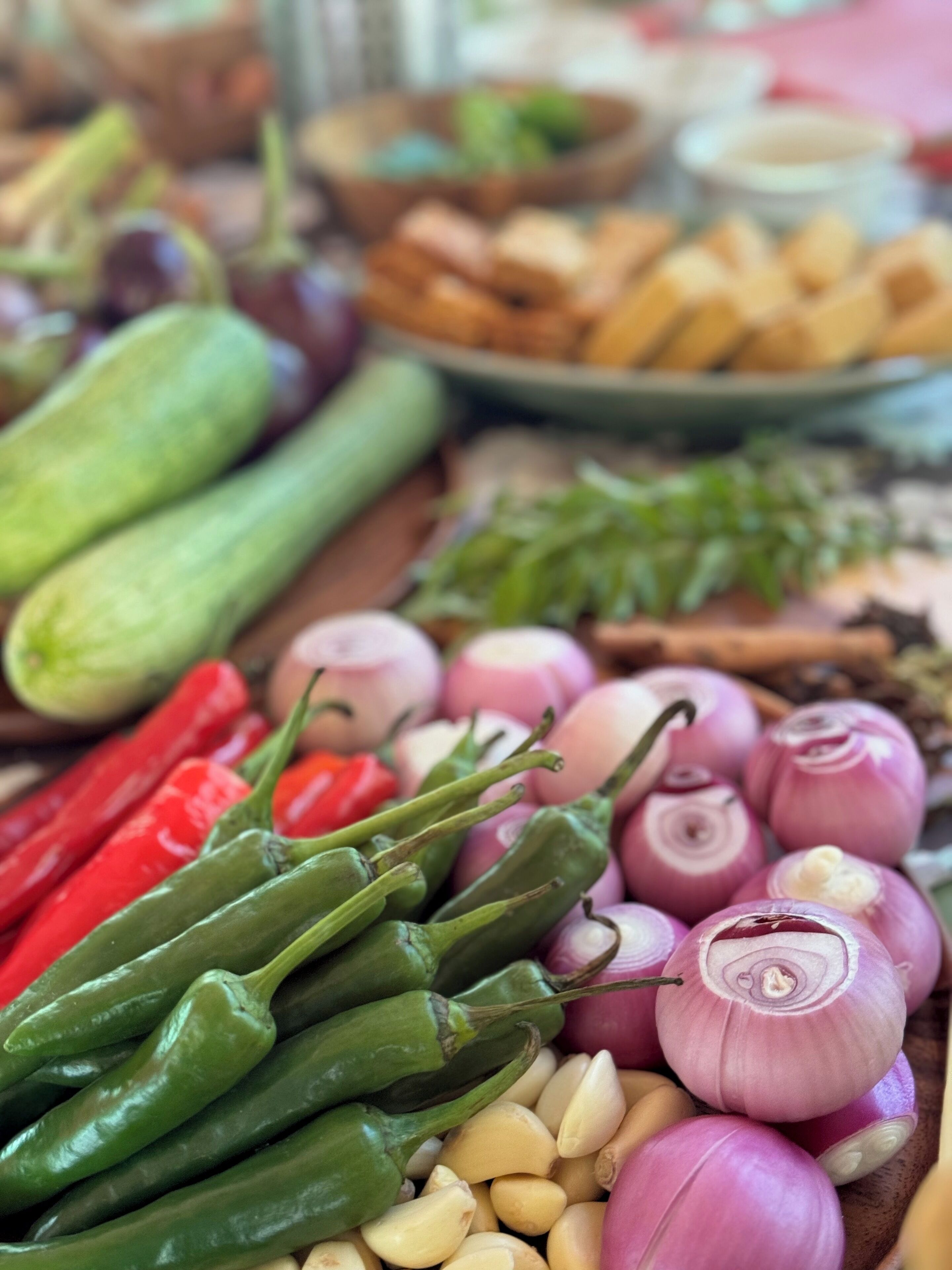 A variety of fresh vegetables including green peppers, red peppers, and onions.