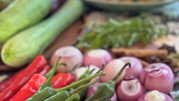 A variety of fresh vegetables including green peppers, red peppers, and onions.