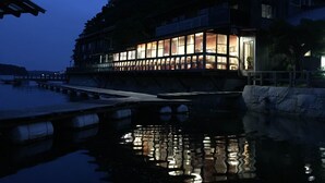 A waterfront building with large windows reflecting on the water. - Hiogiso (Shima)