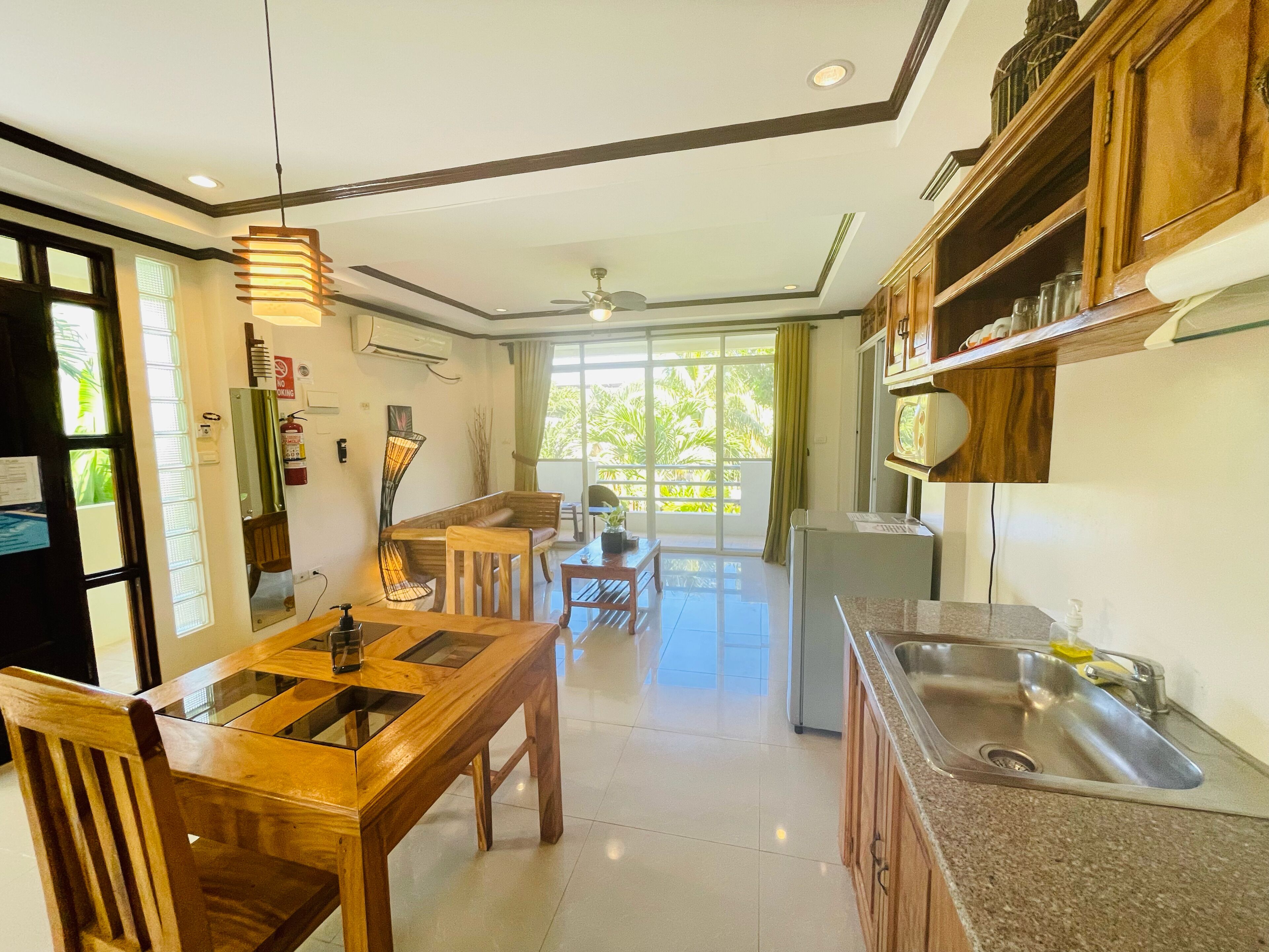 A modern kitchen with wooden cabinets, a dining table, and a built-in sink.