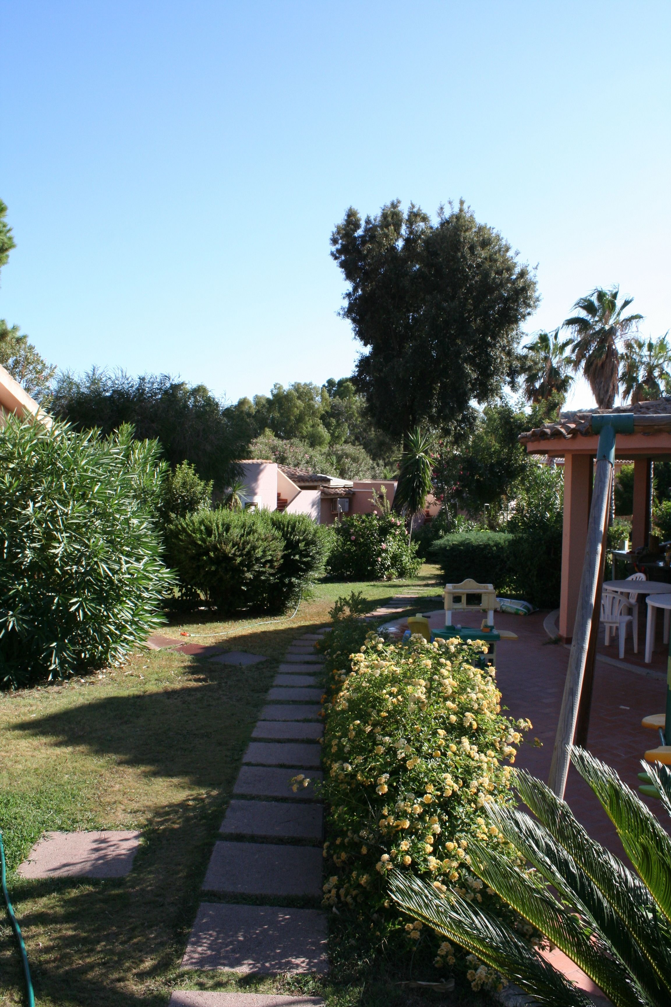 A garden pathway leading to a gazebo with outdoor seating.