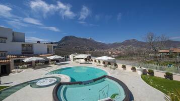 Seasonal outdoor pool, open 10:00 AM to 7:00 PM, pool umbrellas