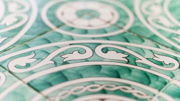 A close-up of a green patterned floor with intricate white designs.