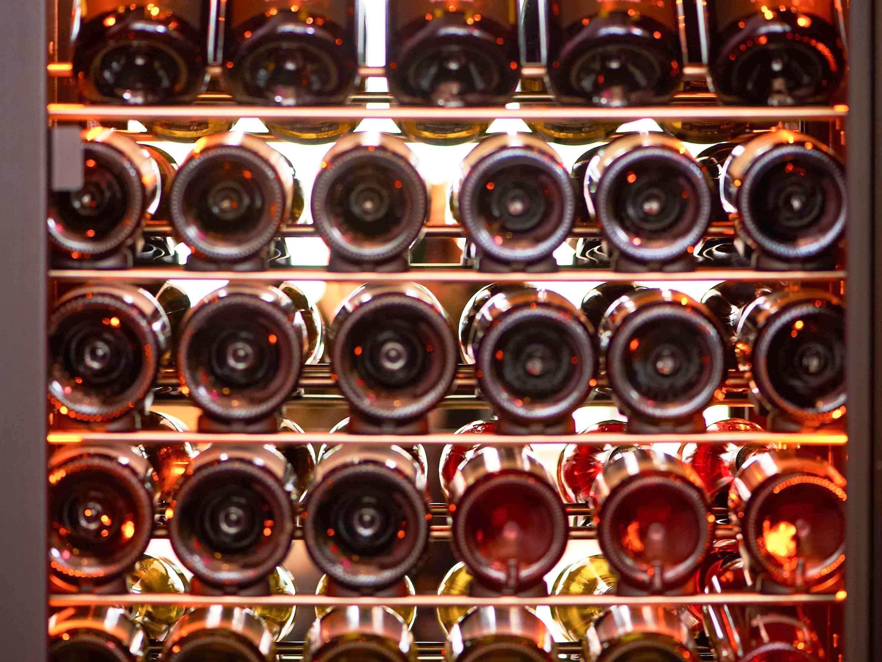 A wine rack with multiple bottles.