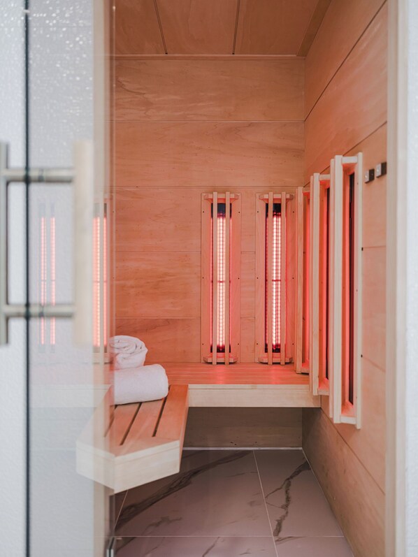 A sauna room with wooden walls and benches.