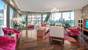 A modern living room with a large window, a chandelier, and a city view. - Hotel Eclat Beijing (Beijing)