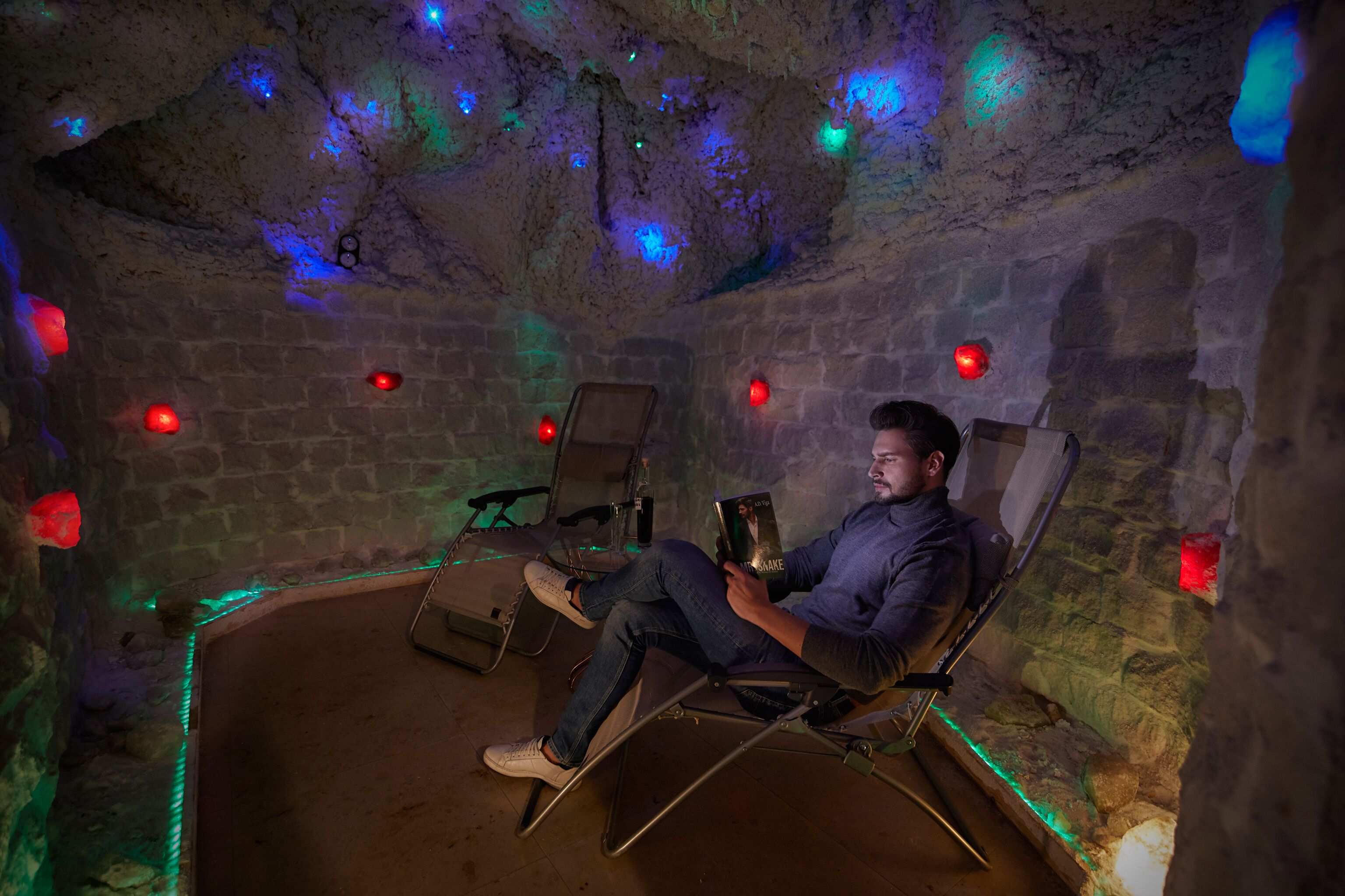 A dimly lit room with stone walls and a single reclining chair.