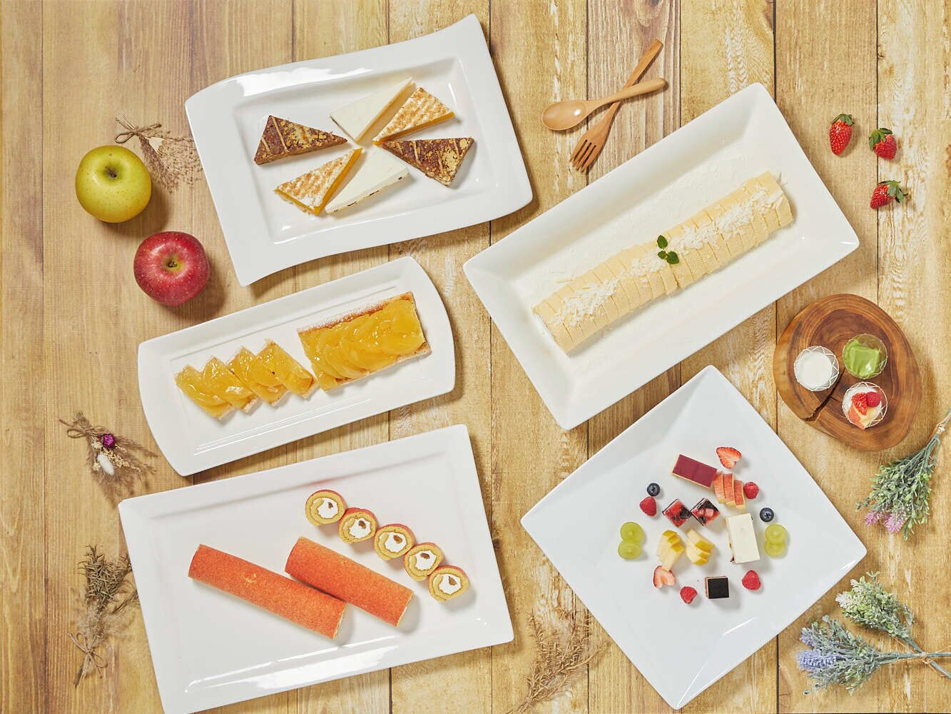 A wooden table with various food items and fruits.