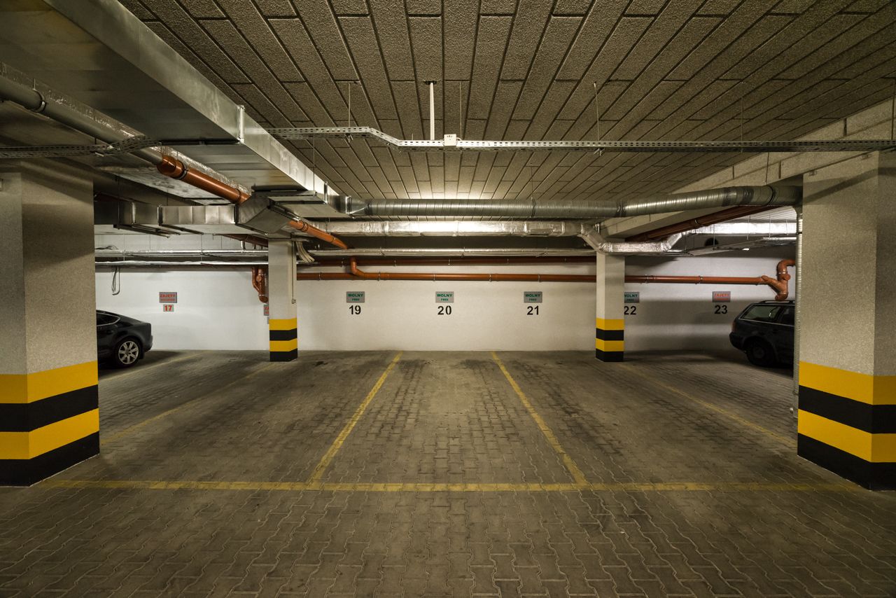 A multi-level parking garage with clearly marked parking spaces numbered 19 to 23.