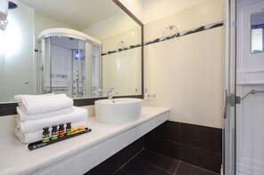 Suite estudio de luna de miel | Baño | Ducha, artículos de higiene personal de diseño y secador de pelo