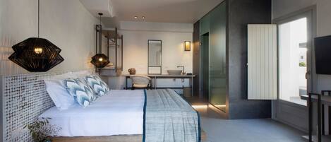 A modern bedroom with a bed, bedside table, and a large mirror.