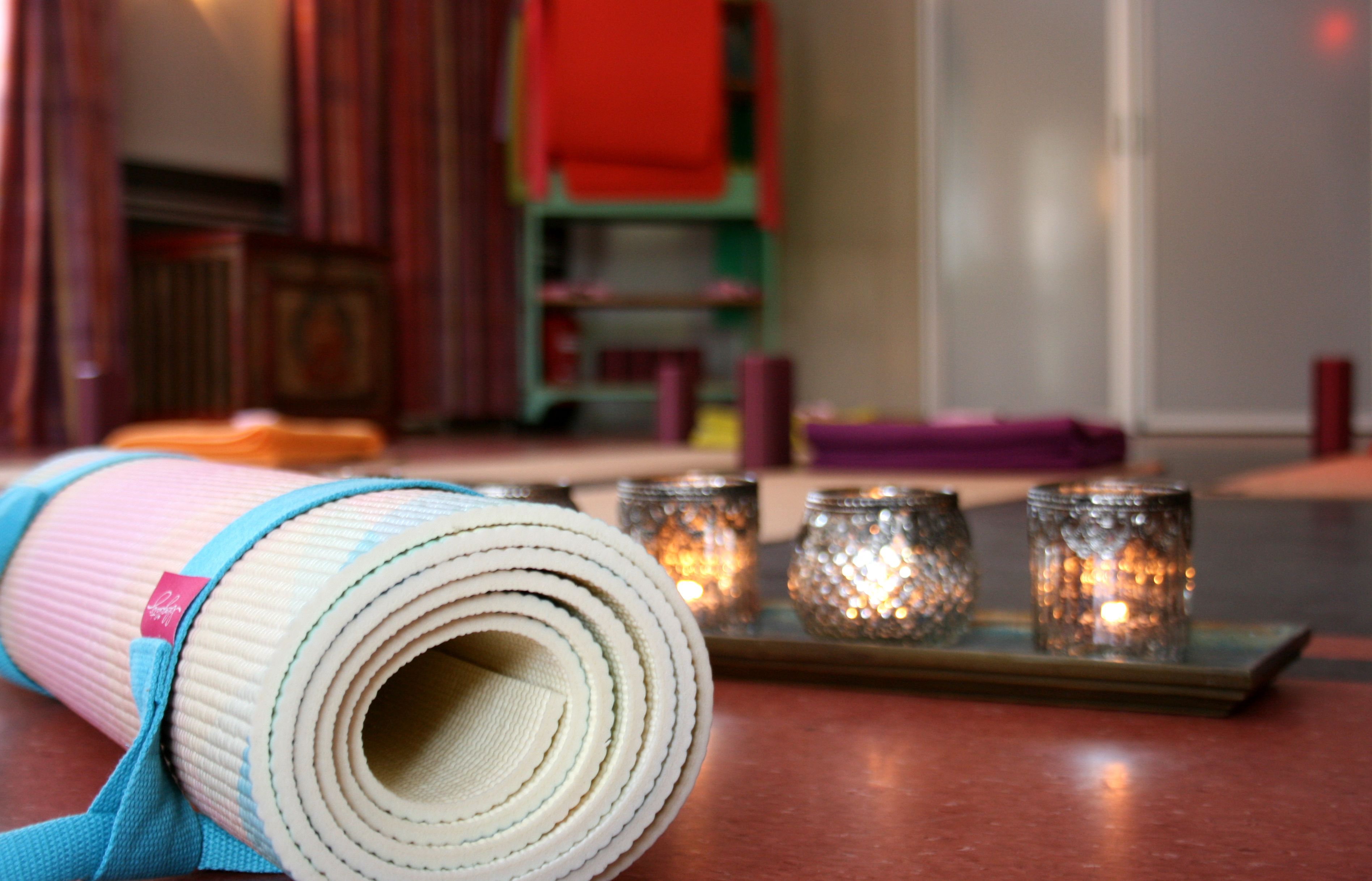 A yoga mat on a tray with candles.