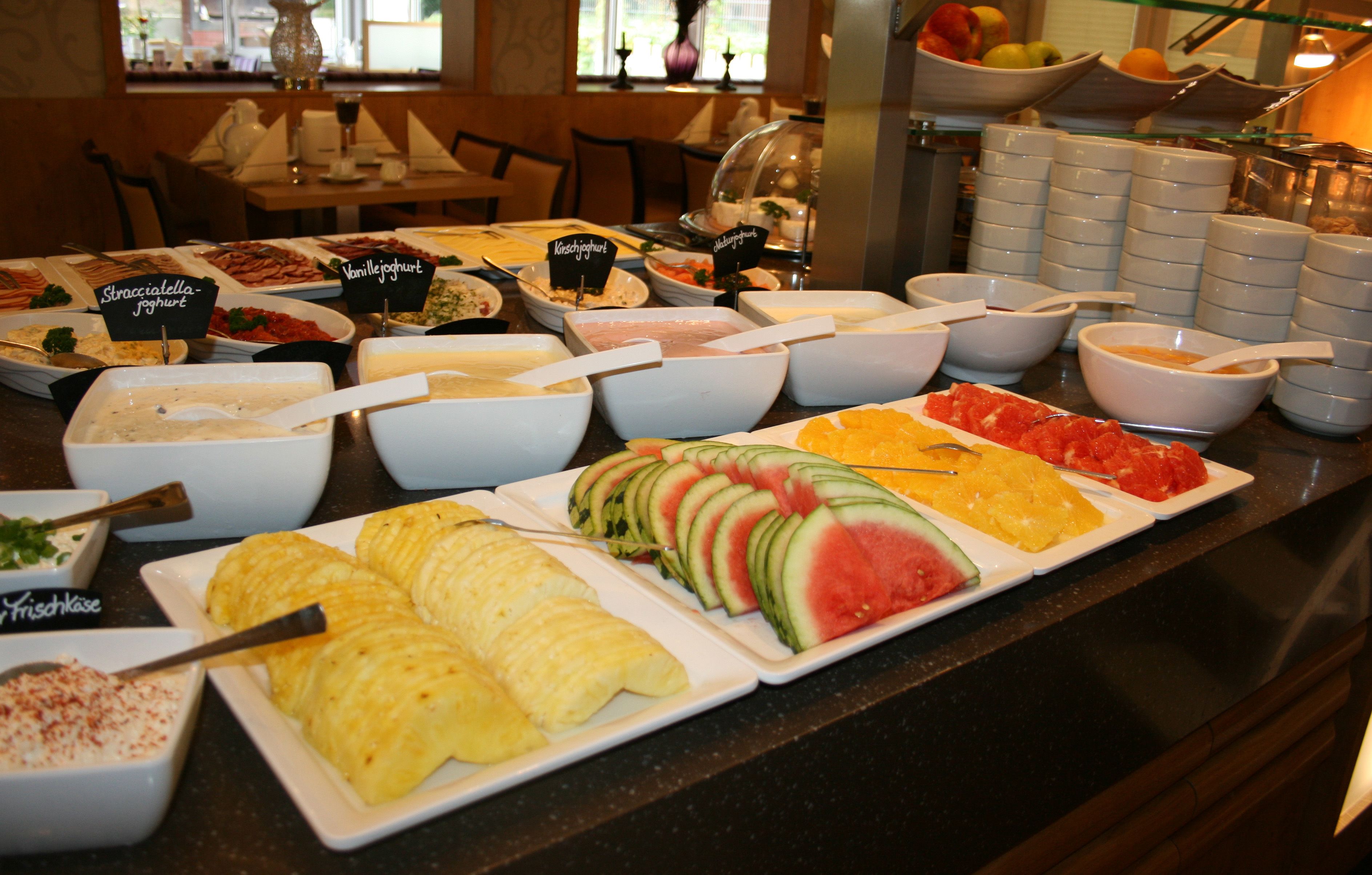 A buffet with various food items and labels.