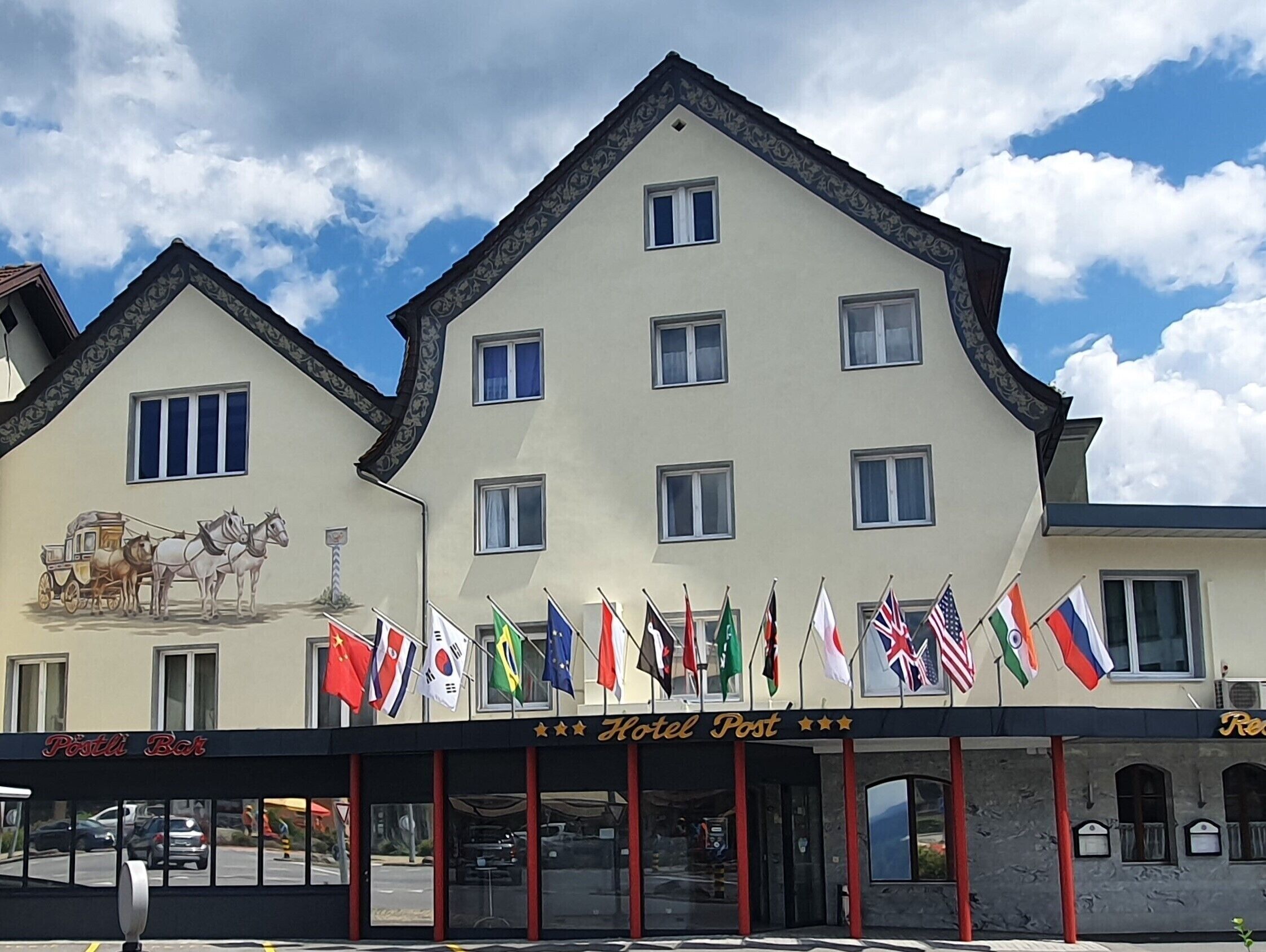 A hotel with a traditional European architectural style, featuring a symmetrical facade with multiple windows and a central entrance.
