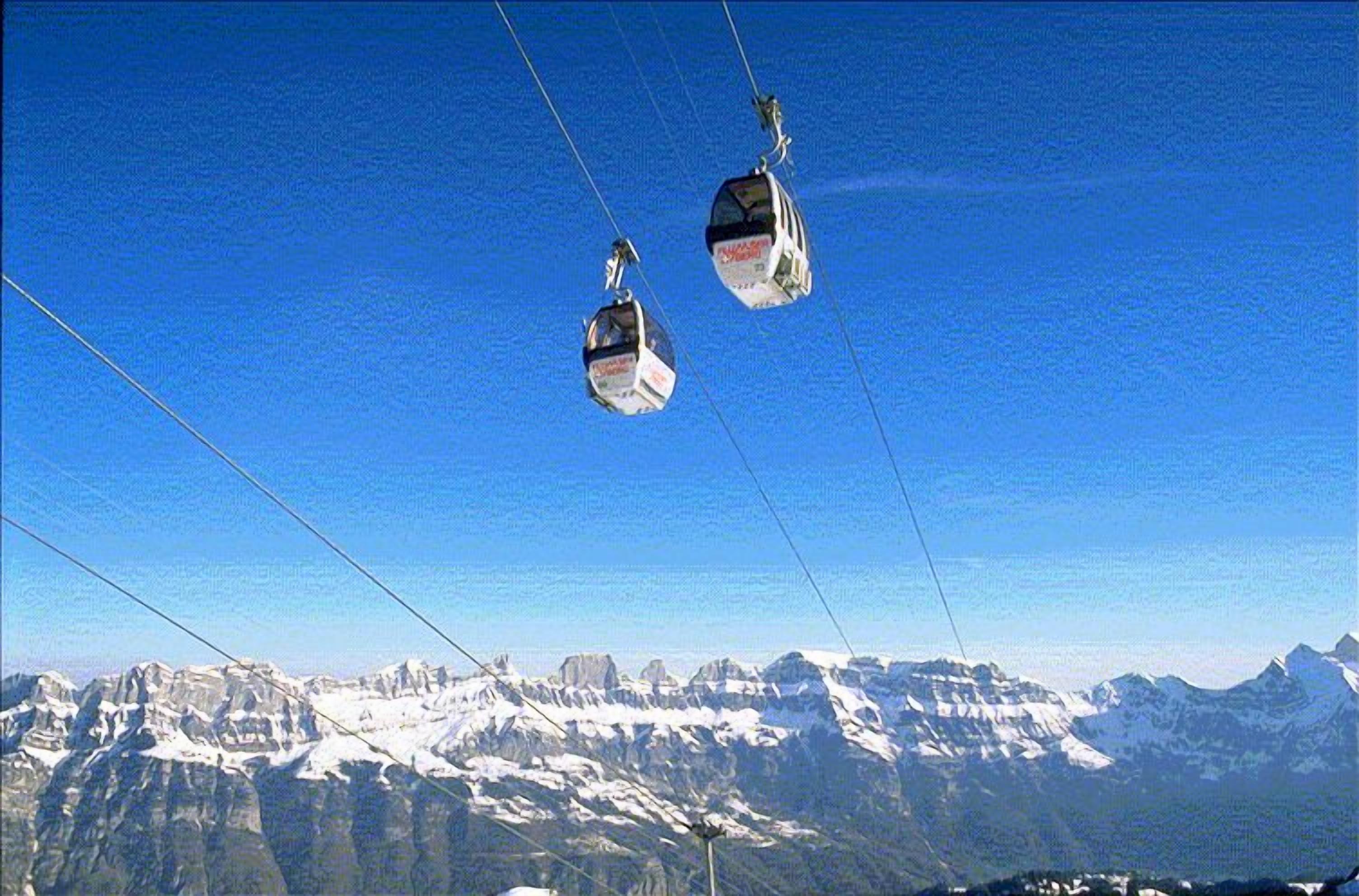 A cable car system with a mountainous landscape in the background.