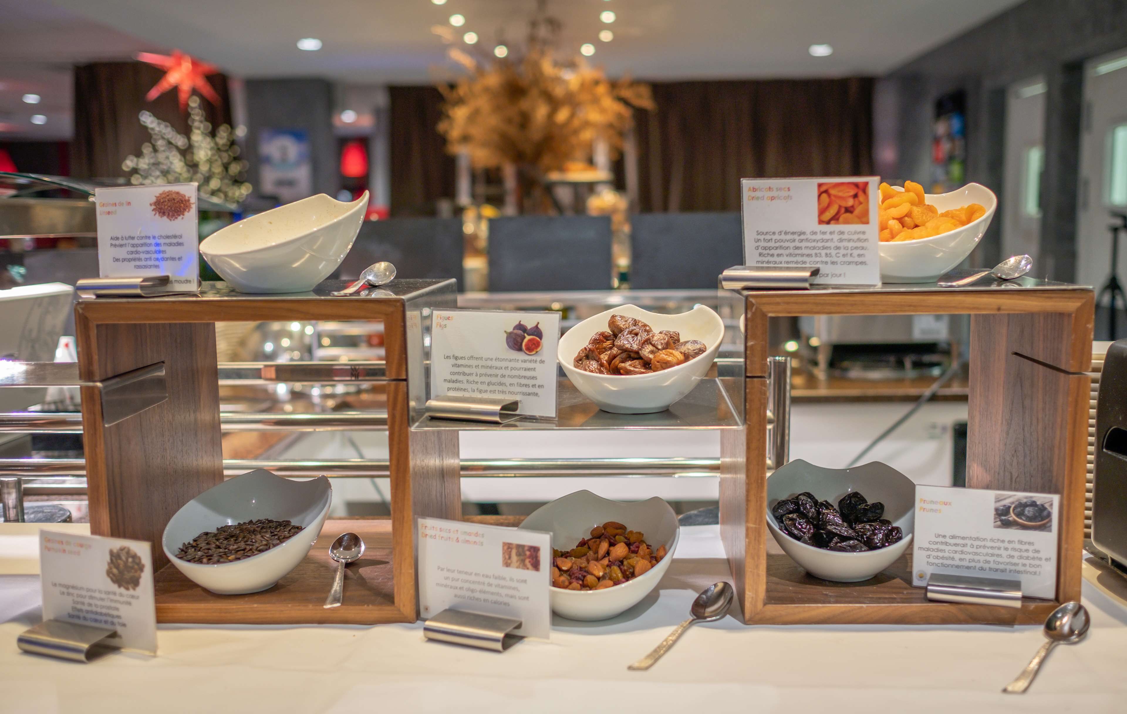 A buffet with various food items displayed in bowls, accompanied by informational signs.