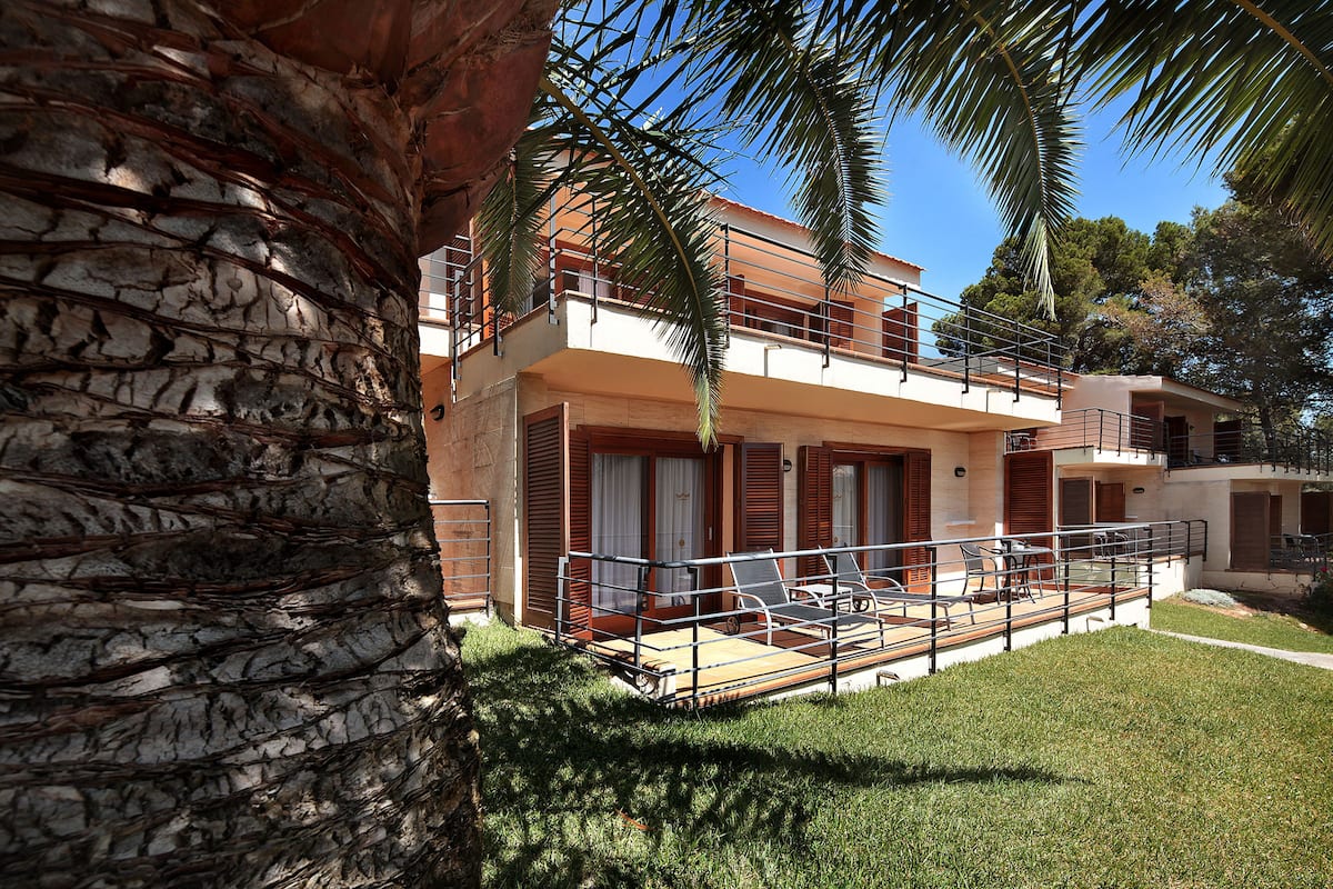 A two-story building with a balcony and a pool area.