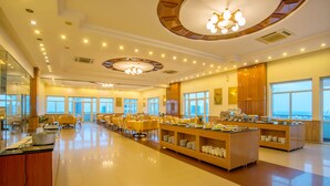 A spacious dining area with multiple tables and a buffet setup. - Golden Sea Hotel (Da Nang)