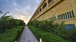 A pathway leading to a building with ornate architectural details and a checkered floor. - Hotel Desert Tulip (Jaisalmer)